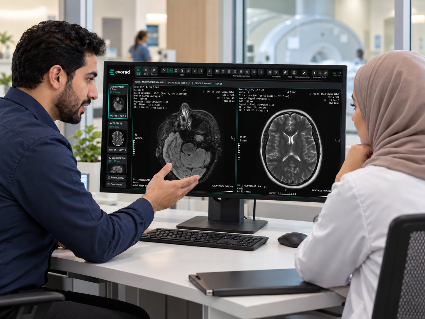 Two clinicians reviewing an MRI study together on an Evorad viewer