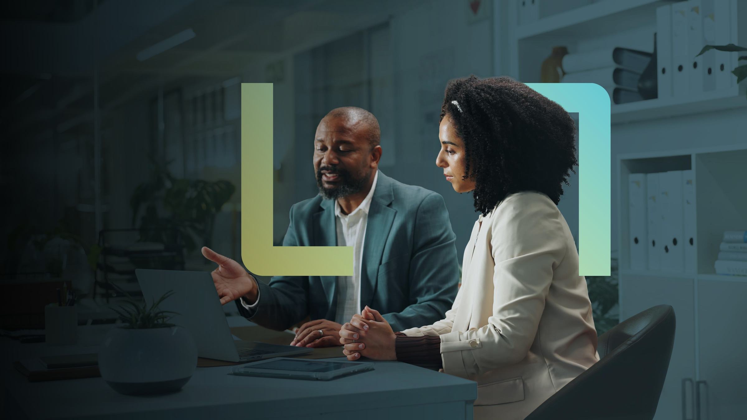 Two Altron colleagues working together at a desk
