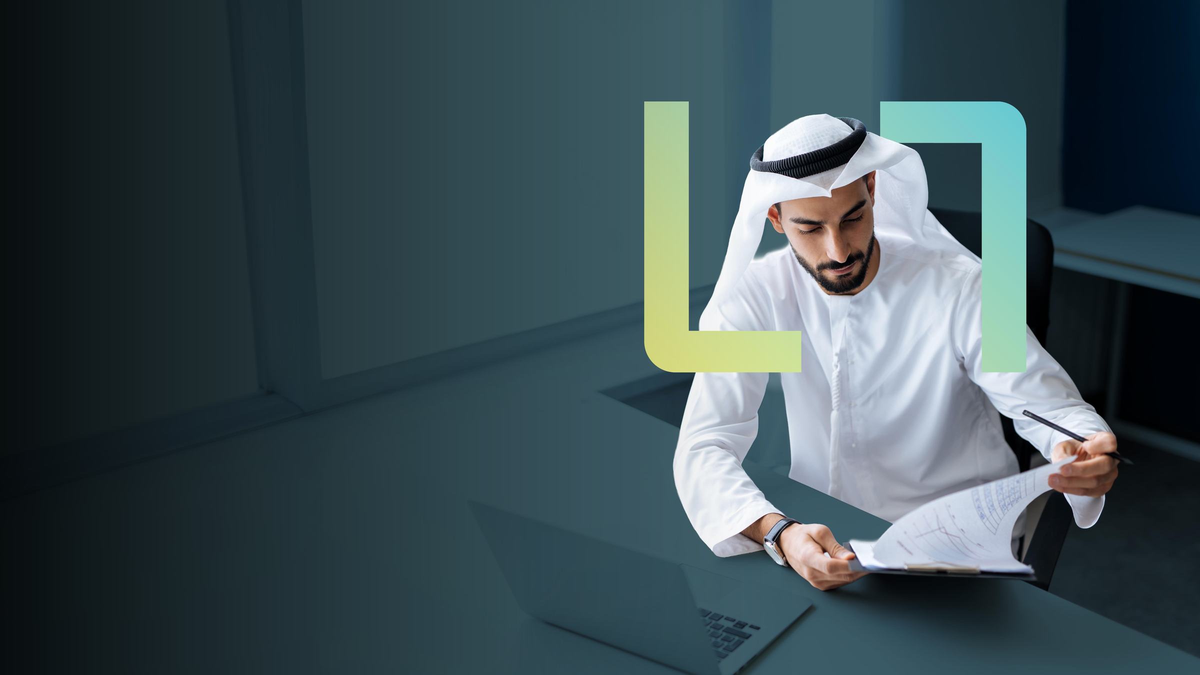A manager reviewing workforce documents at a laptop